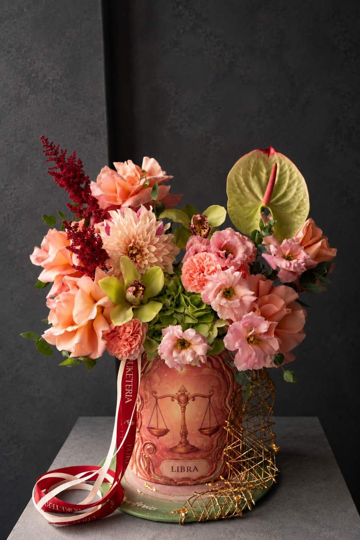 Decorative composition of peach garden roses and hydrangeas in an art box
