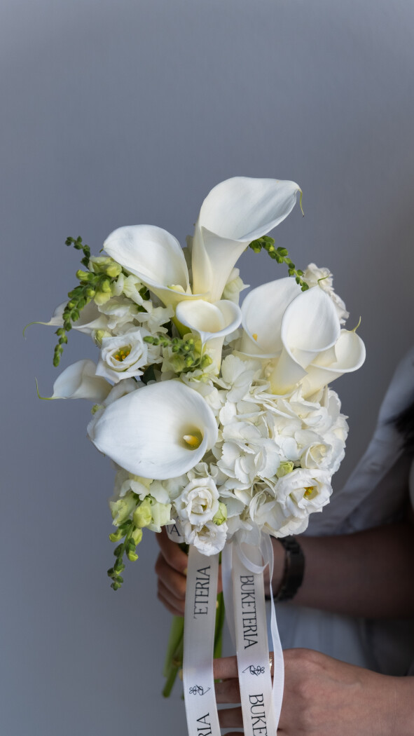 Nine white callas with ten white lisianthus and one white hydrangea