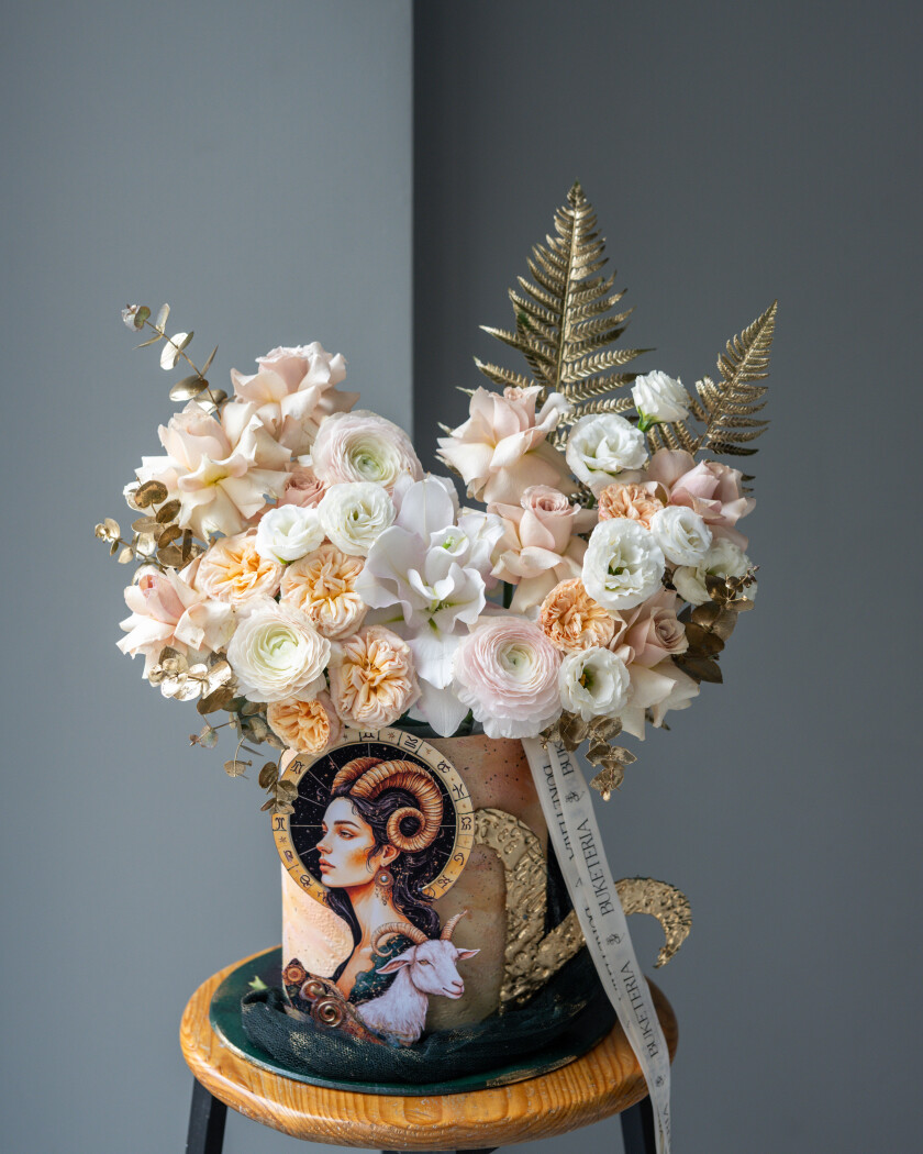 Decorative composition of dusty pink garden roses and white lisianthus