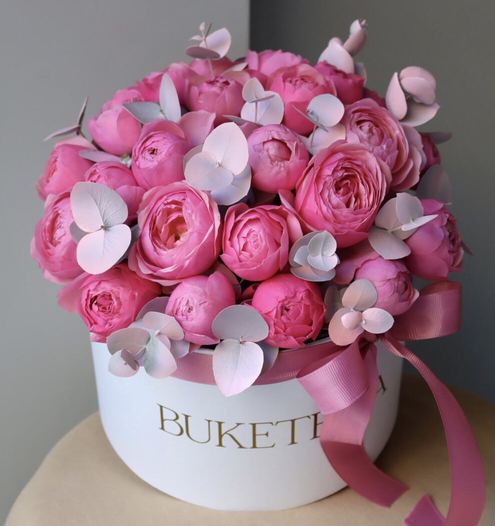 Seven hot pink spray roses in a decorative arrangement