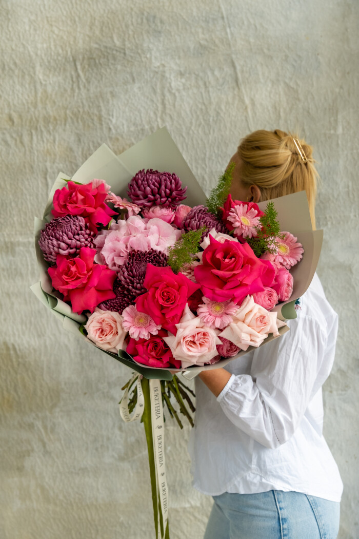 Mixed bouquet of hot pink and light pink garden roses with burgundy chrysanthemums