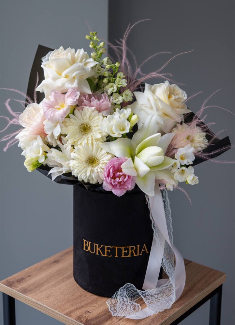 Light blue delphiniums with cream garden roses and blush tulips