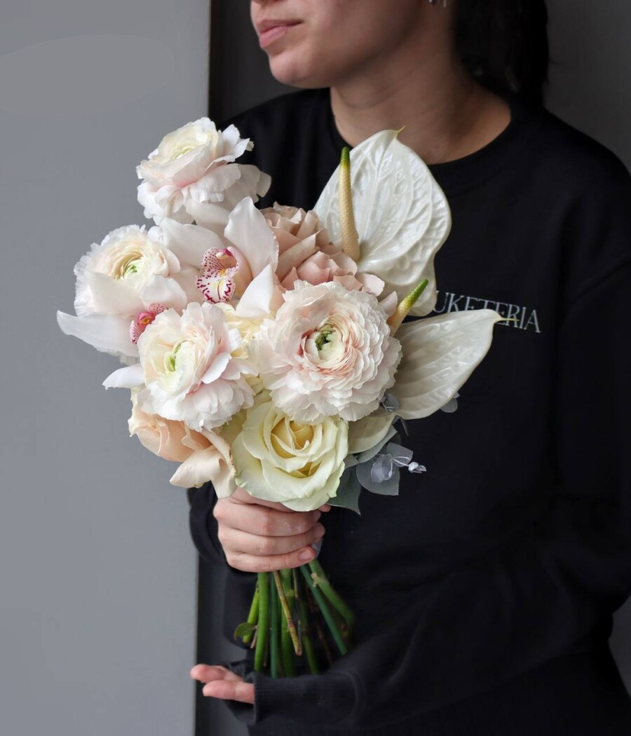 Blush ranunculus with white anthurium and cream roses