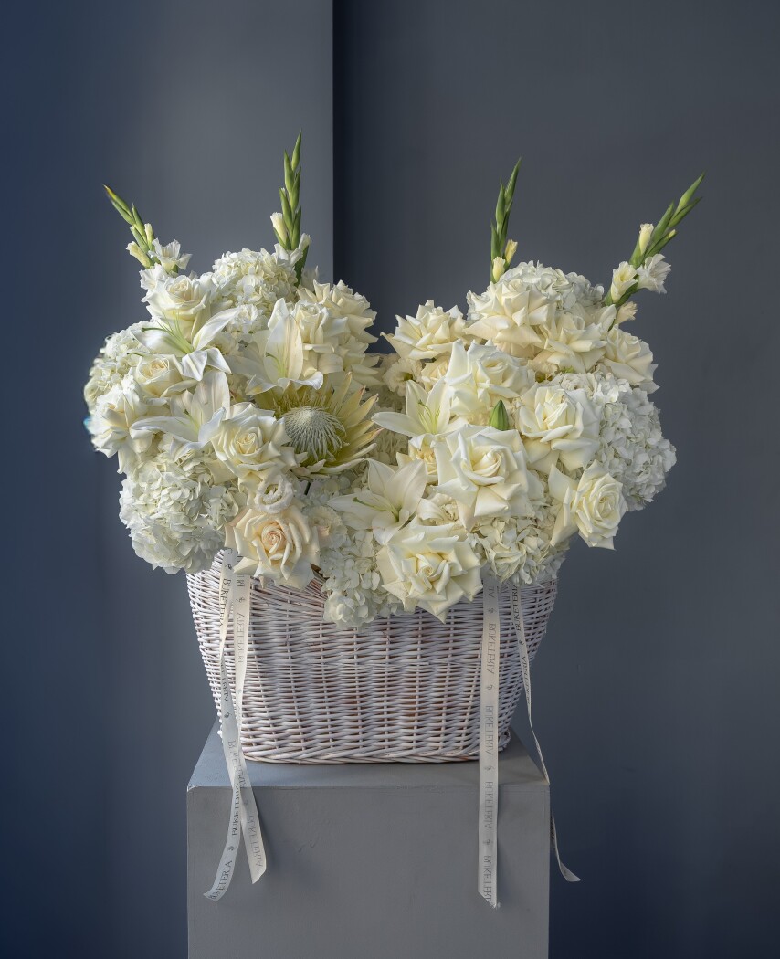Elegant white hydrangeas and garden roses in a basket