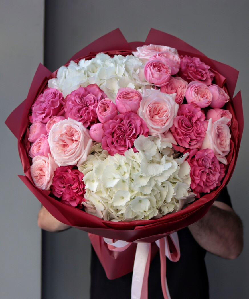 Seven blush garden roses with deep pink spray roses and white hydrangeas