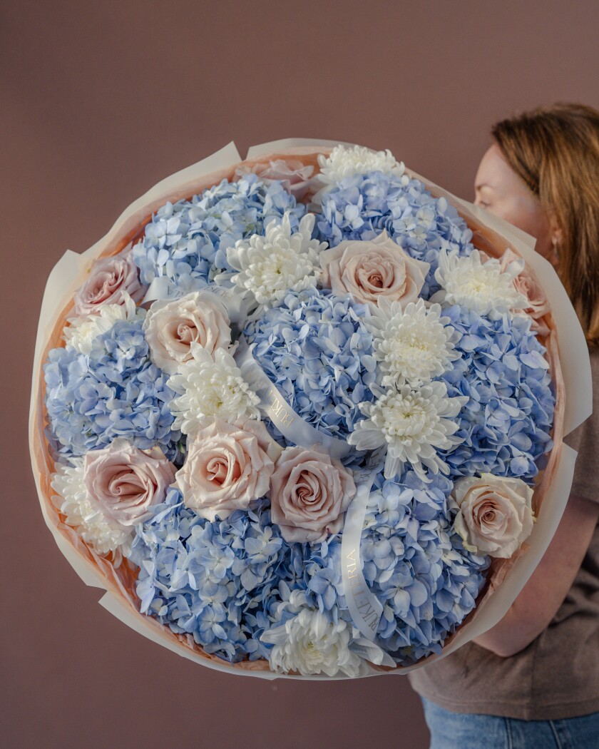 Mixed bouquet of light blue hydrangeas and blush garden roses