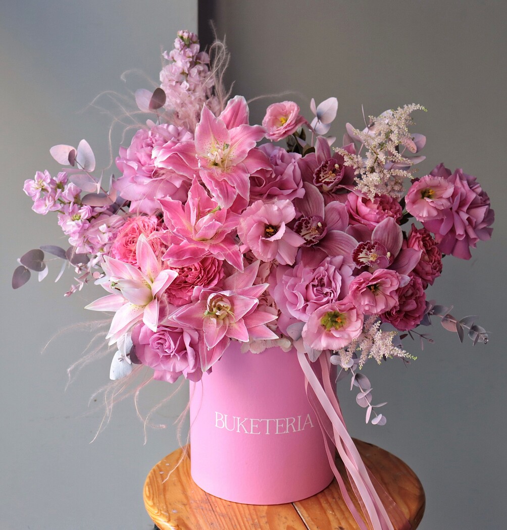 Five dusty pink garden roses with coral lisianthus and peach spray roses