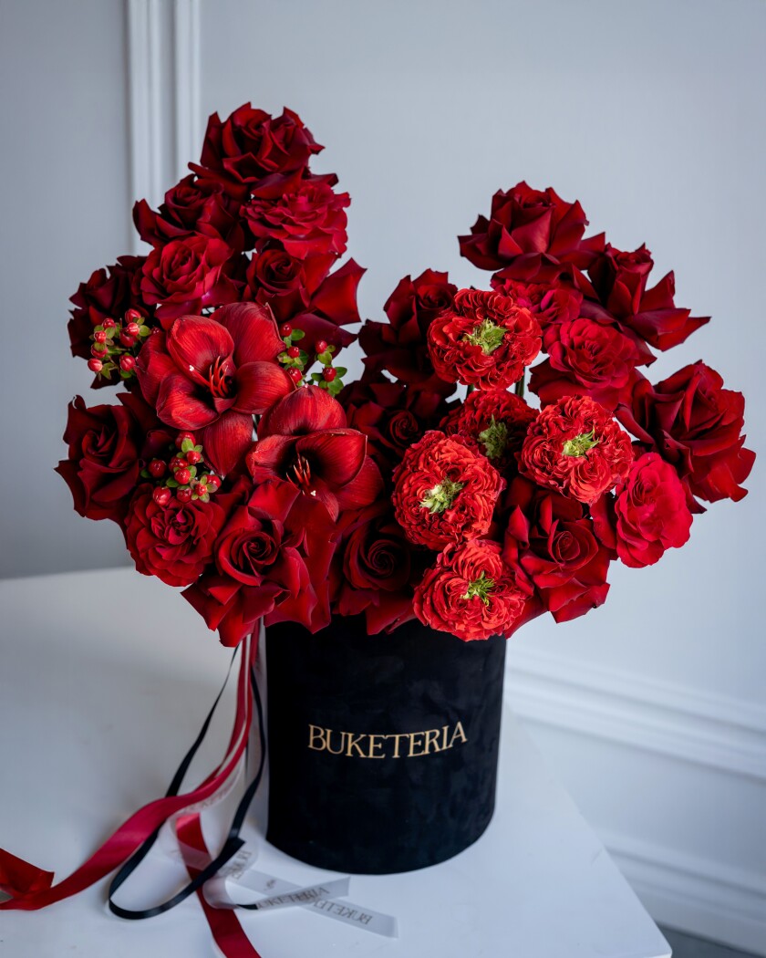 Decorative composition of red roses in a luxury box