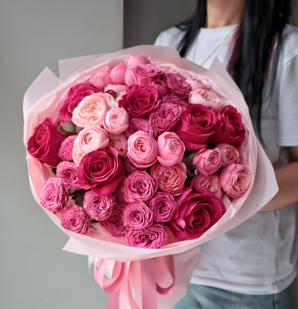 Seven hot pink garden roses and five pink spray roses