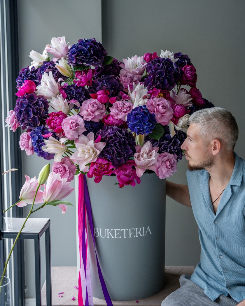 Lilac hydrangeas with coral peonies and dusty pink garden roses