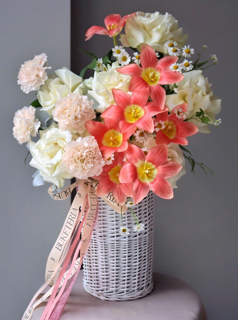 Cheerful composition of cream garden roses and coral tulips