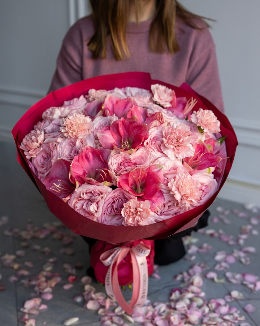 Mixed bouquet of light pink garden roses and hot pink amaryllis