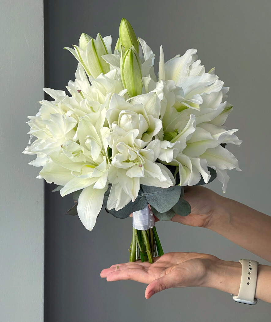 Seven white oriental lilies in a romantic bouquet