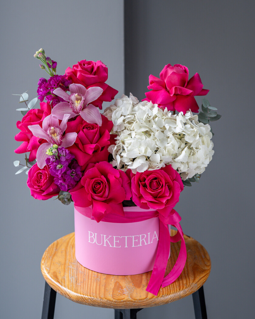 Decorative composition of hot pink garden roses with white hydrangeas