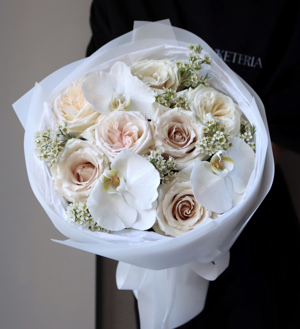 Eight peach garden roses and three white phalaenopsis orchids