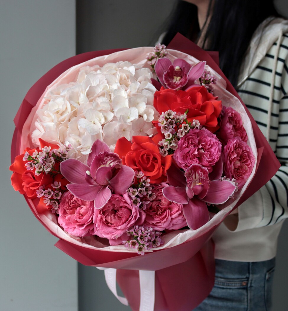 Mixed bouquet of red spray roses and lavender cymbidium orchids