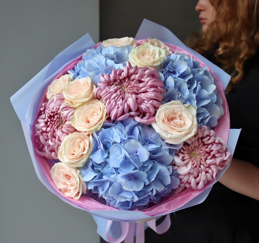 Mixed bouquet of cream roses, blue hydrangeas, and dusty pink chrysanthemums
