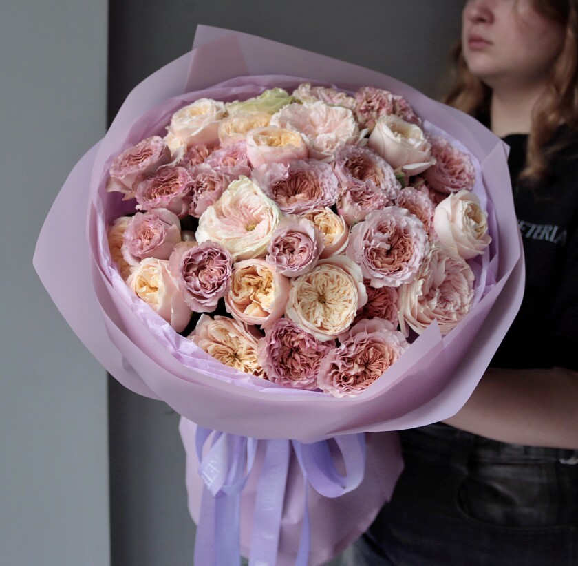 Twelve dusty pink spray roses in waterproof paper