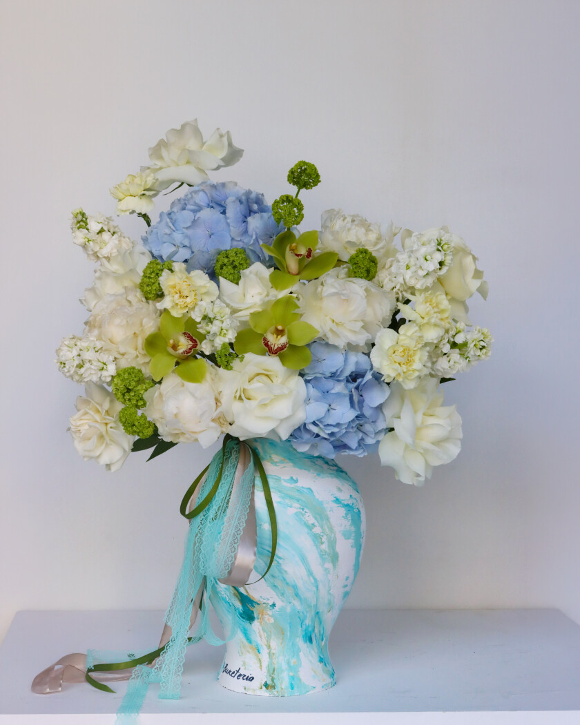 Decorative composition of white hybrid tea roses and peonies