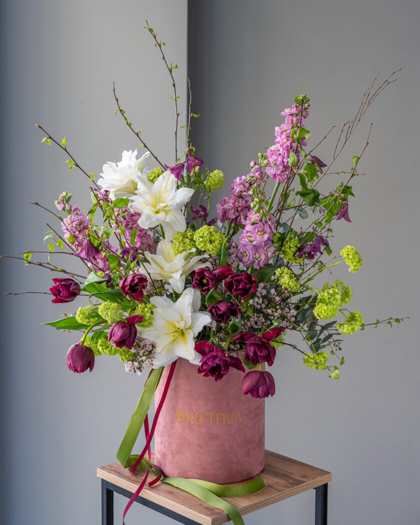 Ten burgundy tulips with green viburnum and purple clematis
