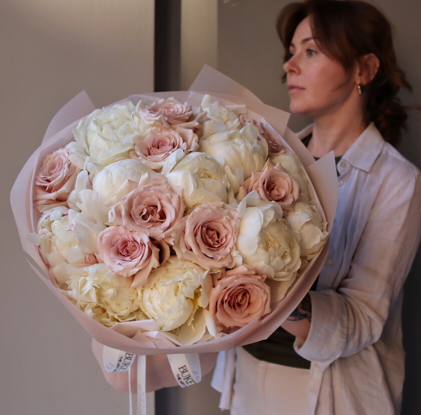 Eleven white peonies and nine blush garden roses