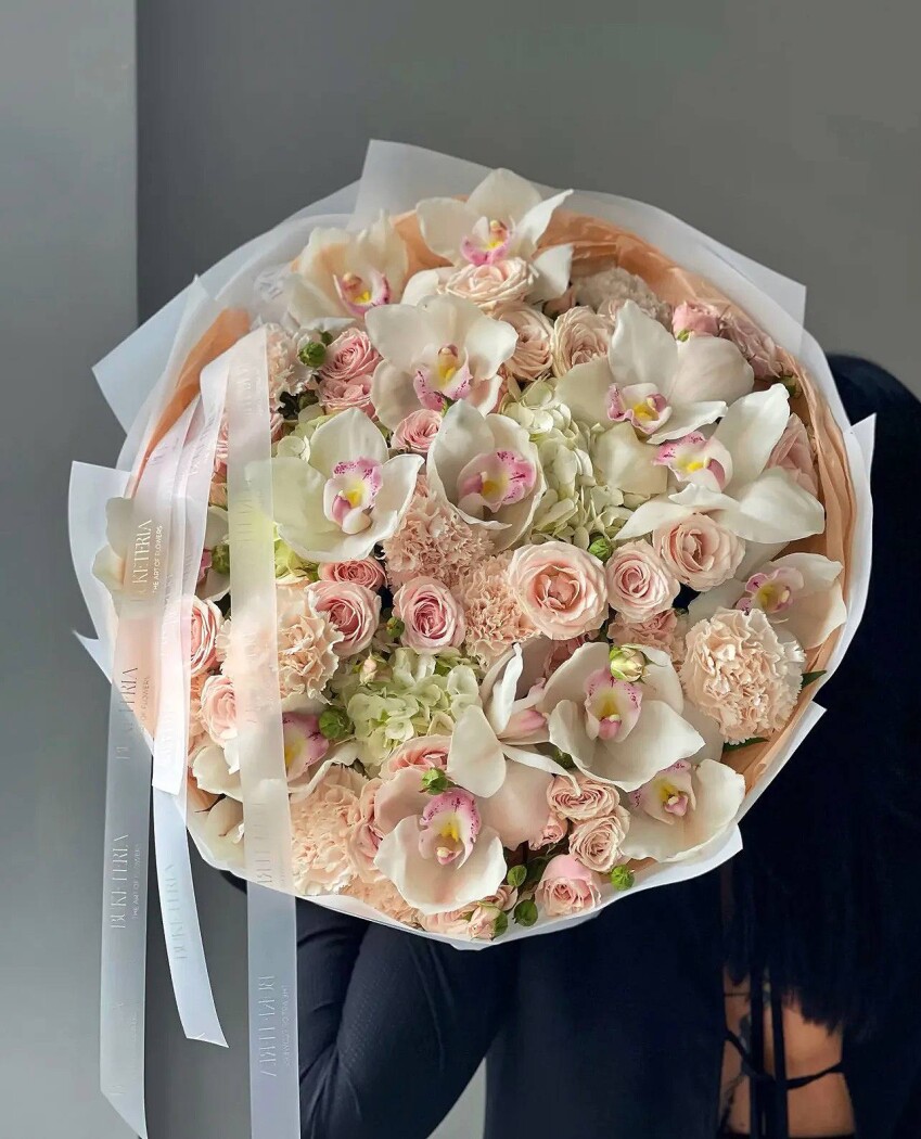 Mixed bouquet of white cymbidium orchids and light pink spray roses