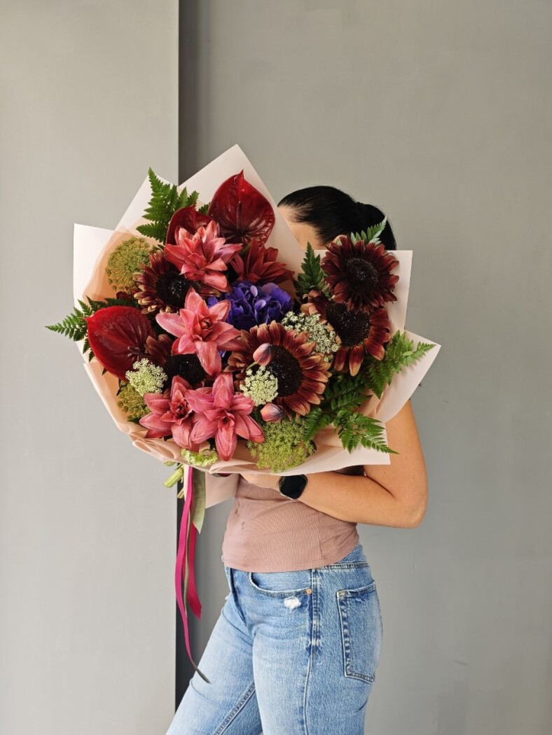 Burgundy sunflowers with red anthuriums and lilac hydrangea