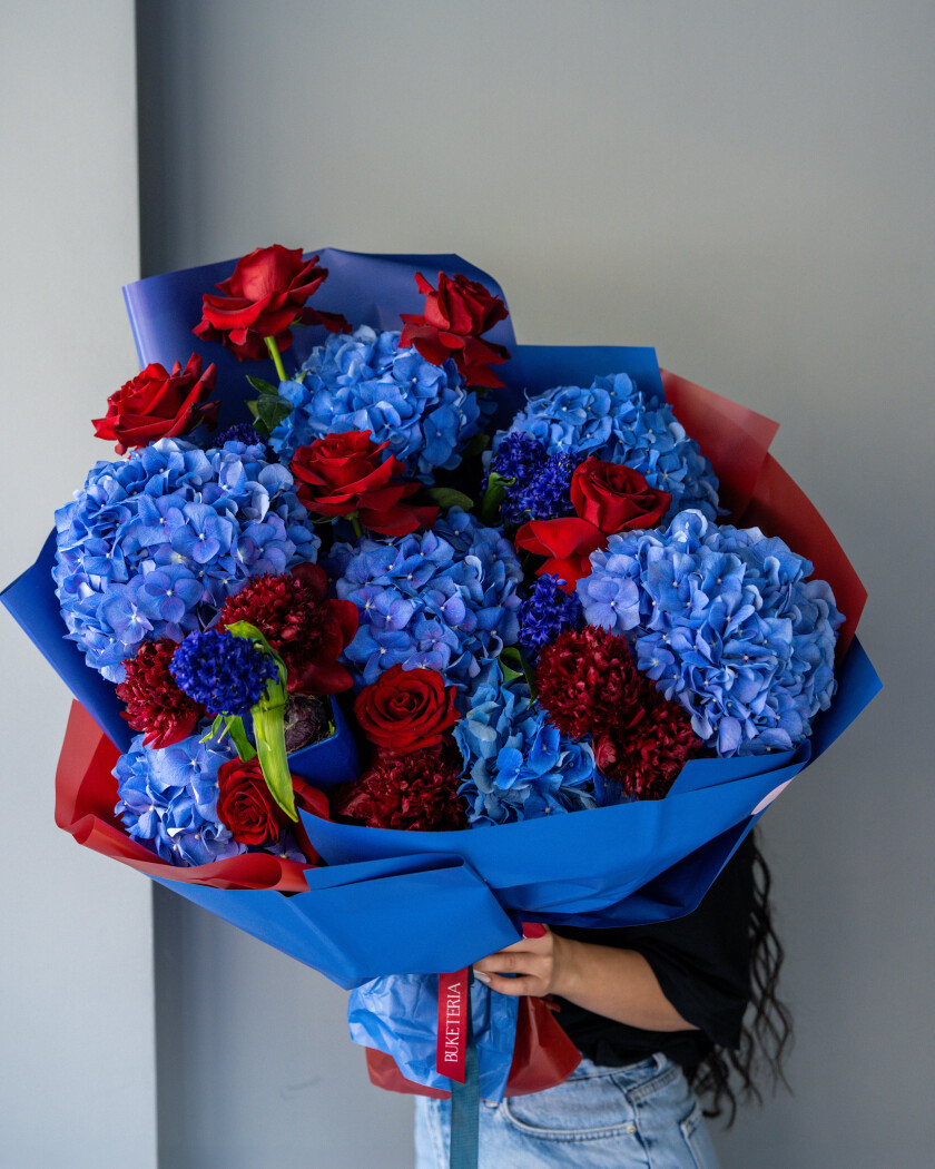 Blue hydrangeas with red peonies and burgundy hyacinths