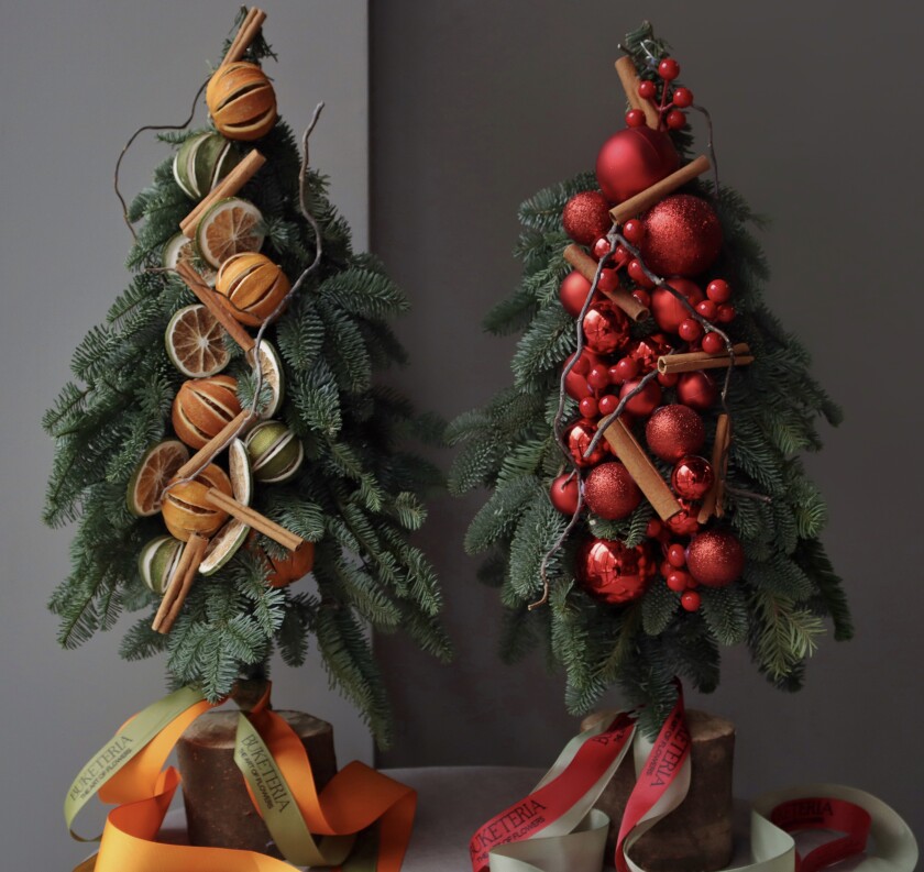 Decorative arrangement of red roses with noble fir and cinnamon
