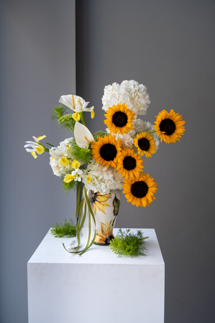 Cheerful arrangement of white hydrangeas and yellow sunflowers