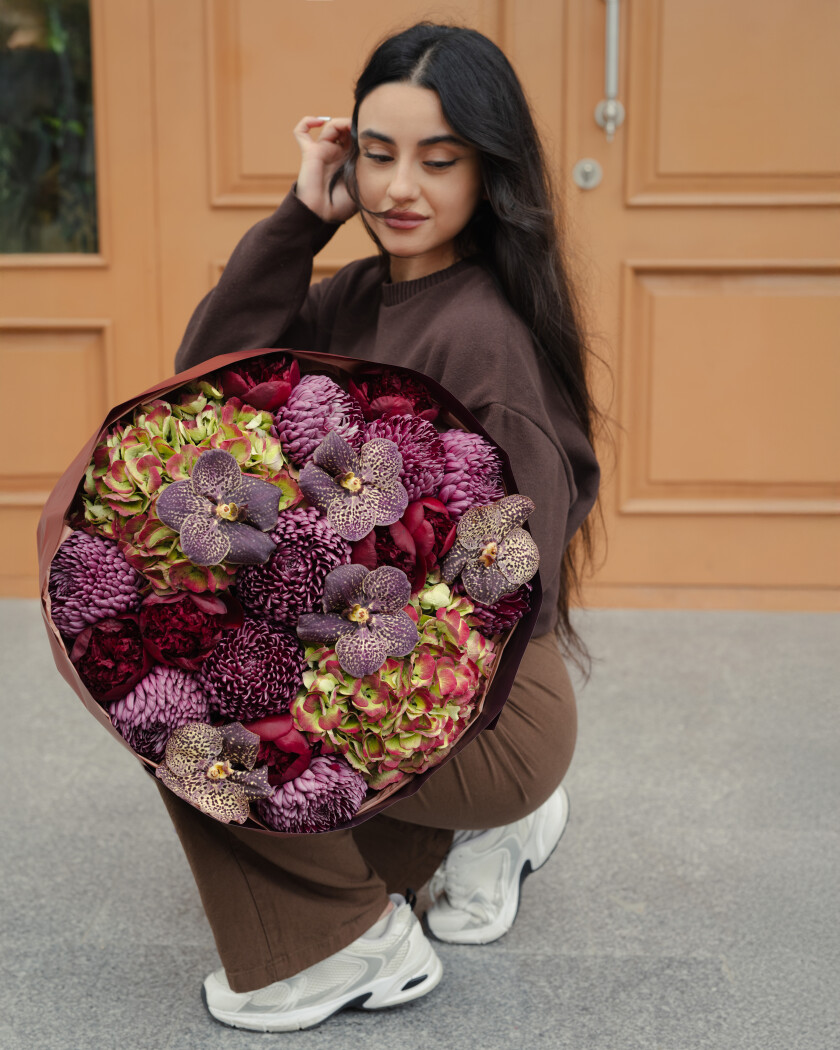 Nine burgundy chrysanthemums and seven red peonies
