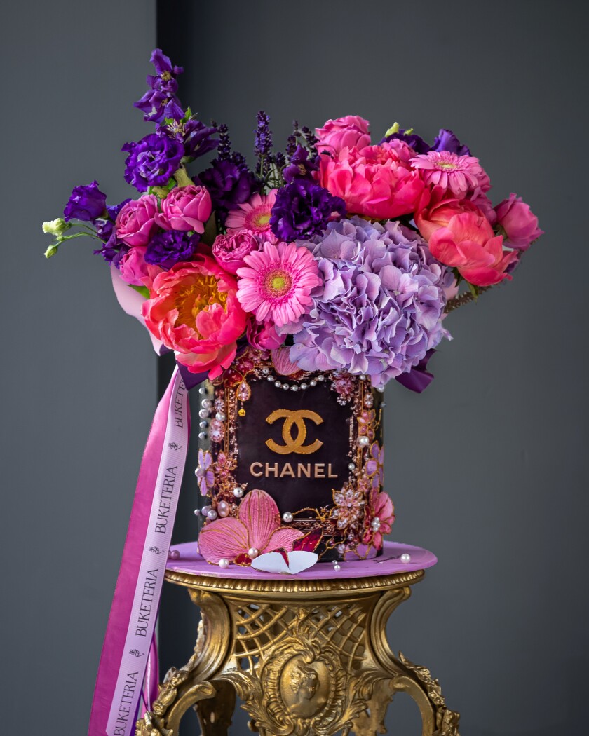 Decorative composition of coral peonies and hot pink spray roses