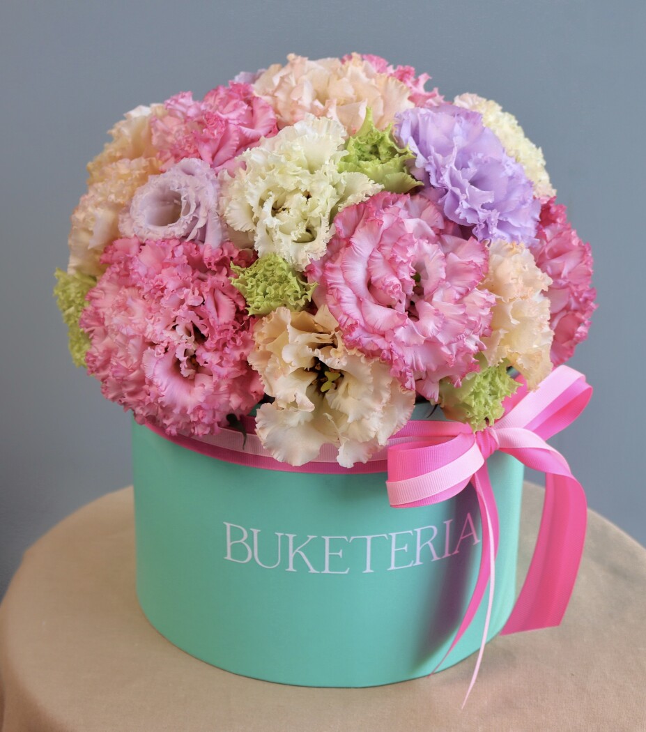 Eleven light pink lisianthus in a decorative composition