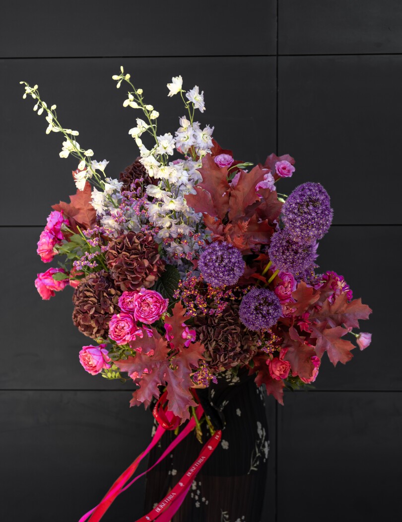 Five burgundy hydrangeas with hot pink spray roses and purple alliums
