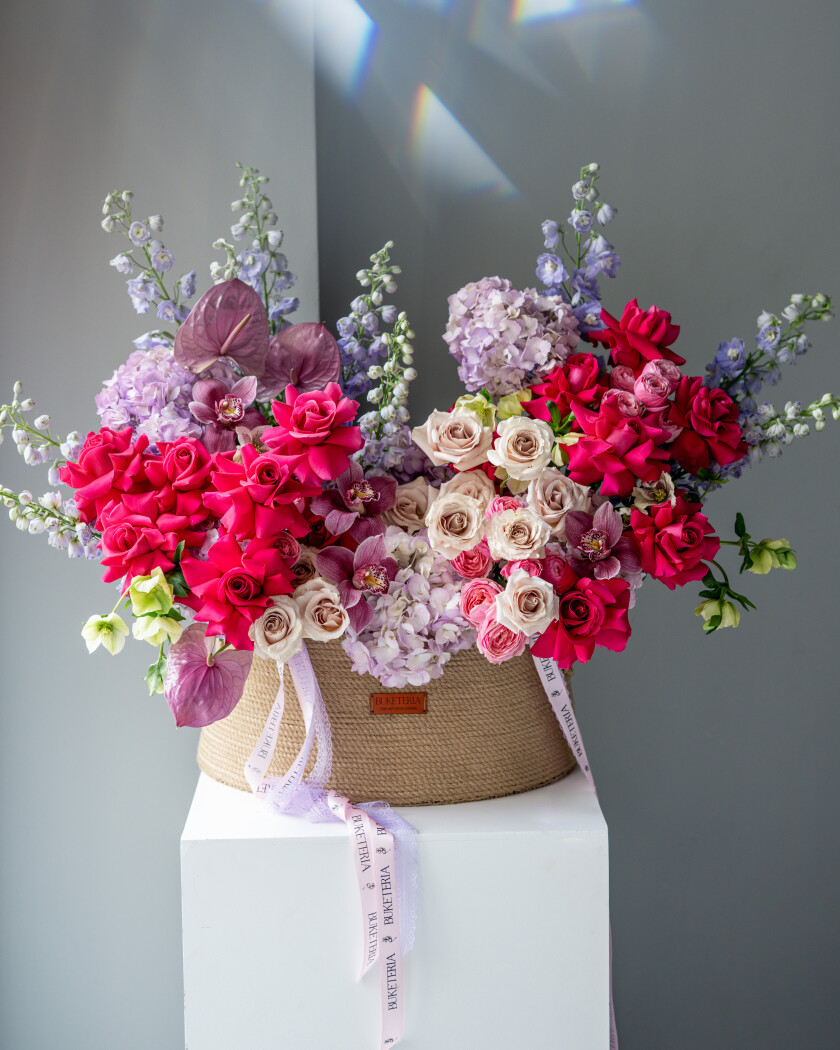 Peach and hot pink garden roses with light blue hydrangeas