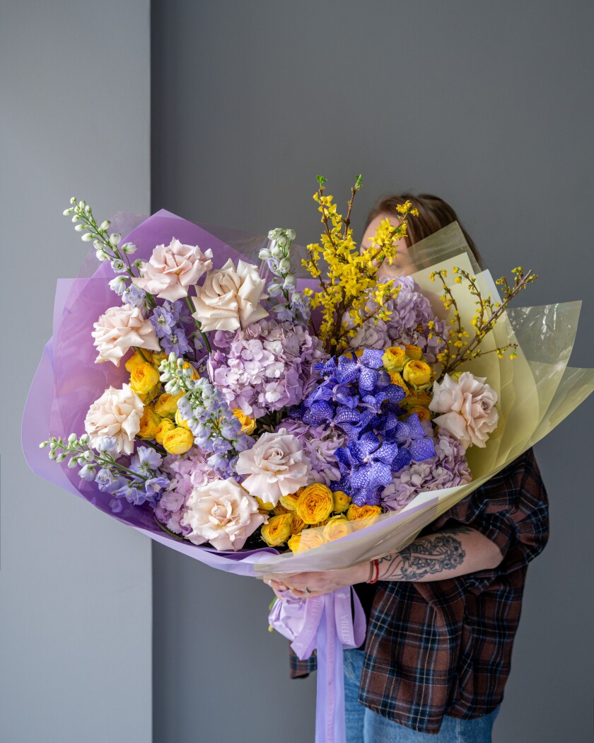 Purple vanda orchids with lavender hydrangeas and yellow roses