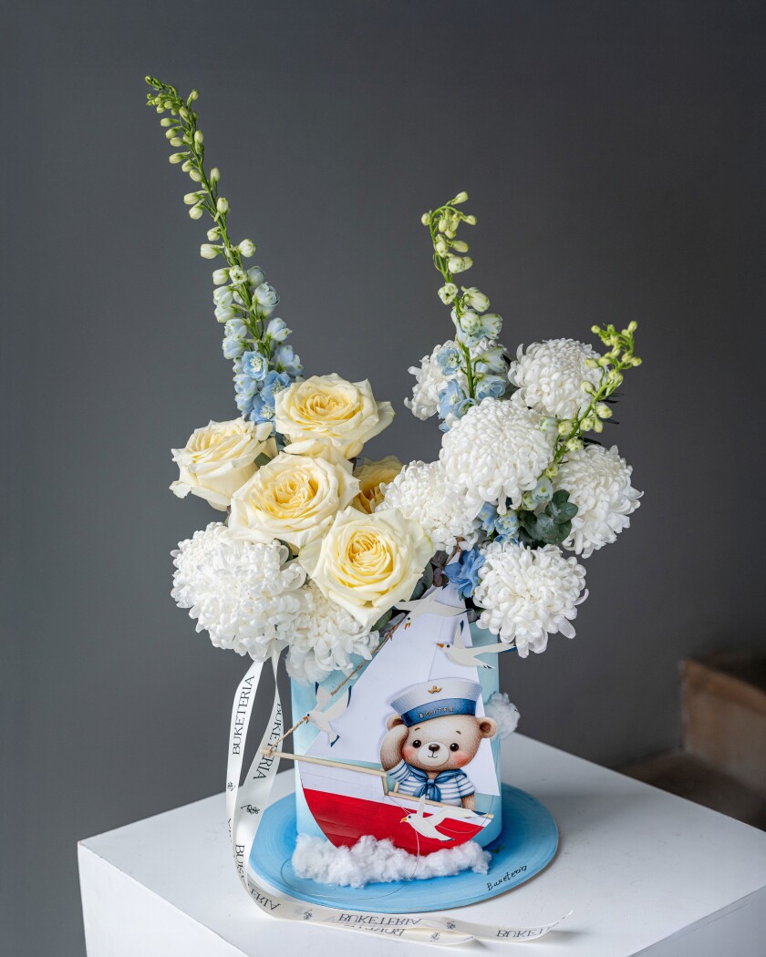 Decorative composition of white chrysanthemums and light blue delphiniums