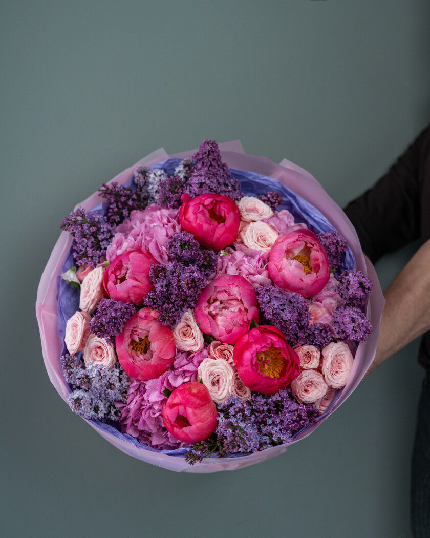 Mixed bouquet of blush spray roses, hot pink peonies, and purple lilacs