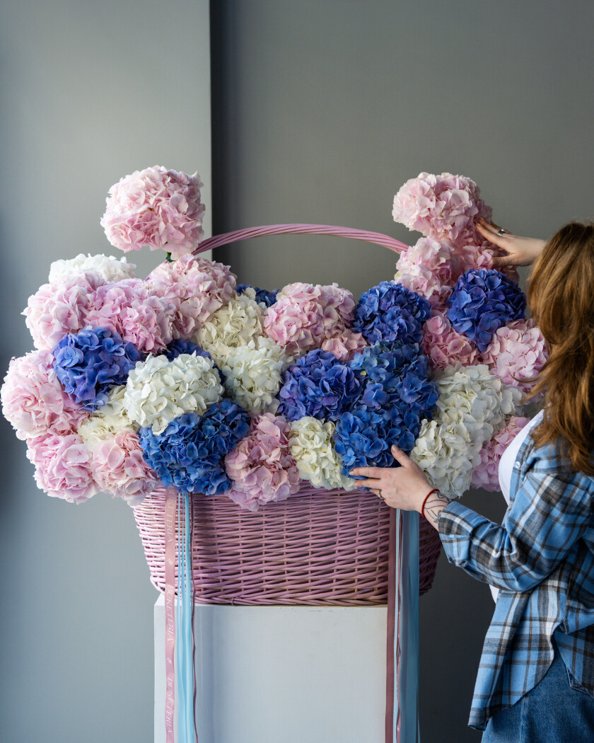 Elegant pink hydrangea composition in a basket