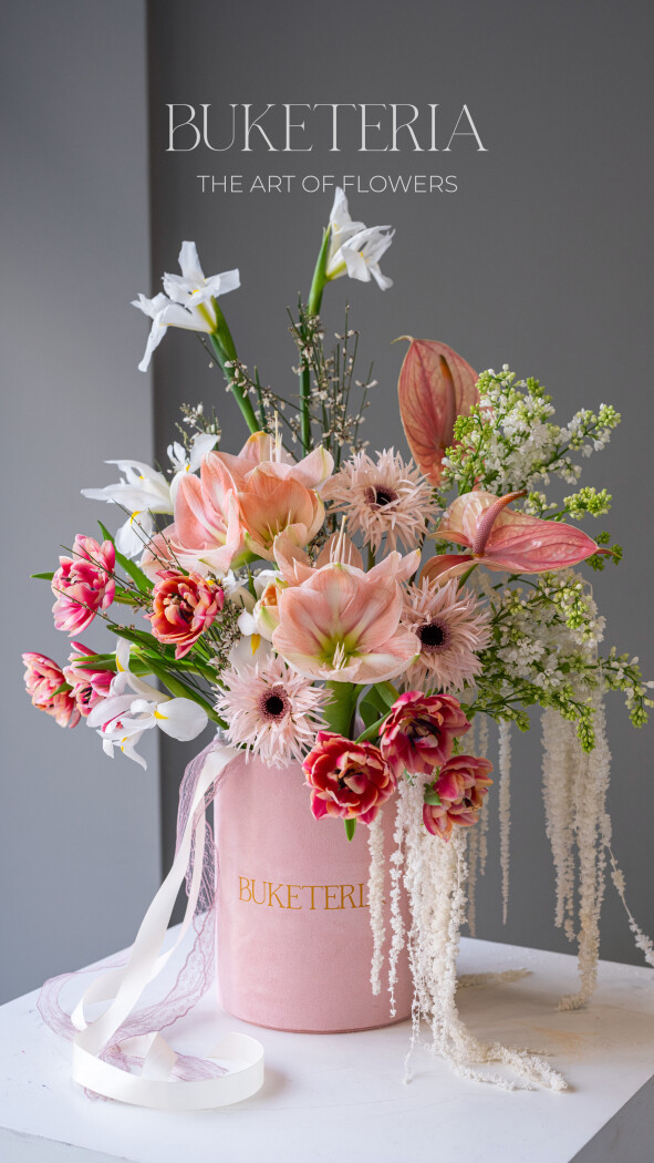 Decorative composition of light pink lilacs and peach amaryllis