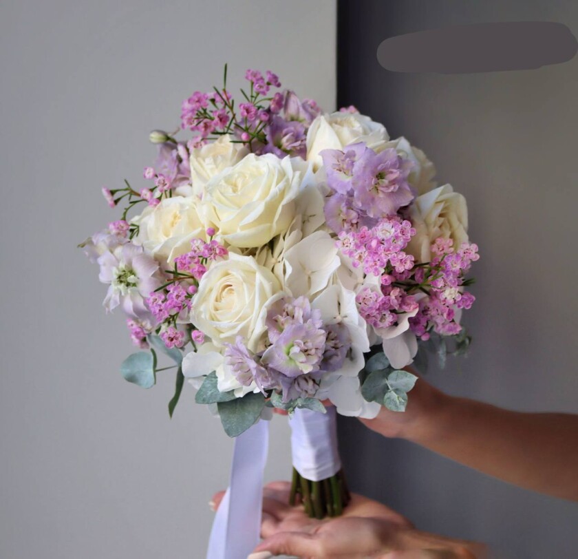 Light pink spray roses with white hydrangeas and lavender delphiniums