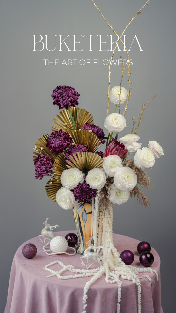 Eleven white ranunculus with purple chrysanthemums and a protea