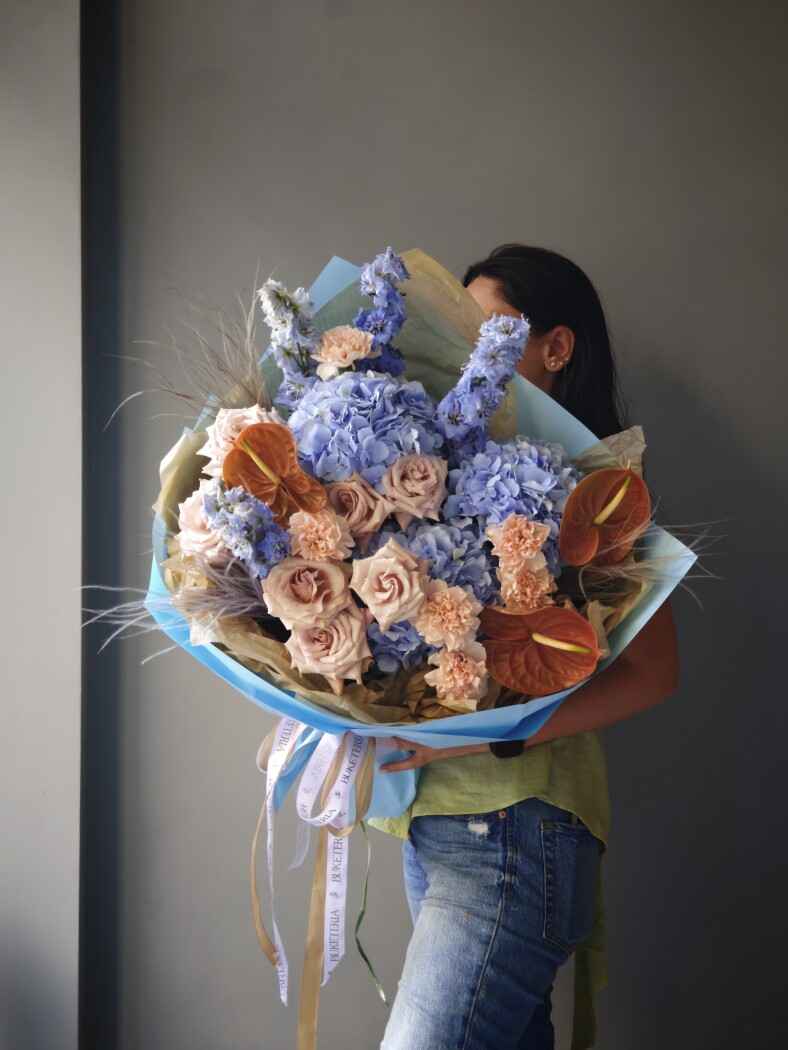Four blue delphiniums with hydrangeas and dusty pink garden roses