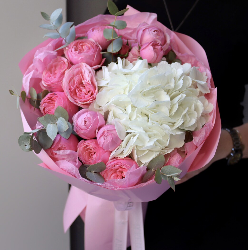 Three light pink spray roses with white hydrangea