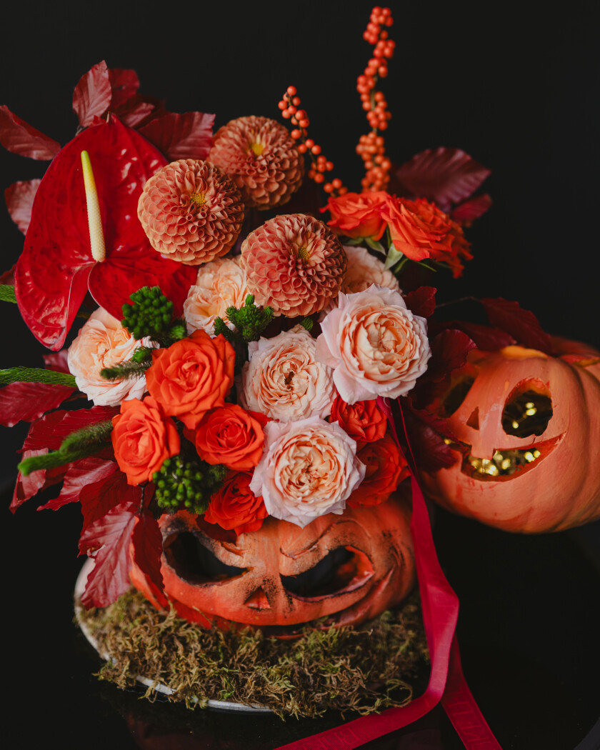 Peach dahlias with orange and apricot roses and red anthurium