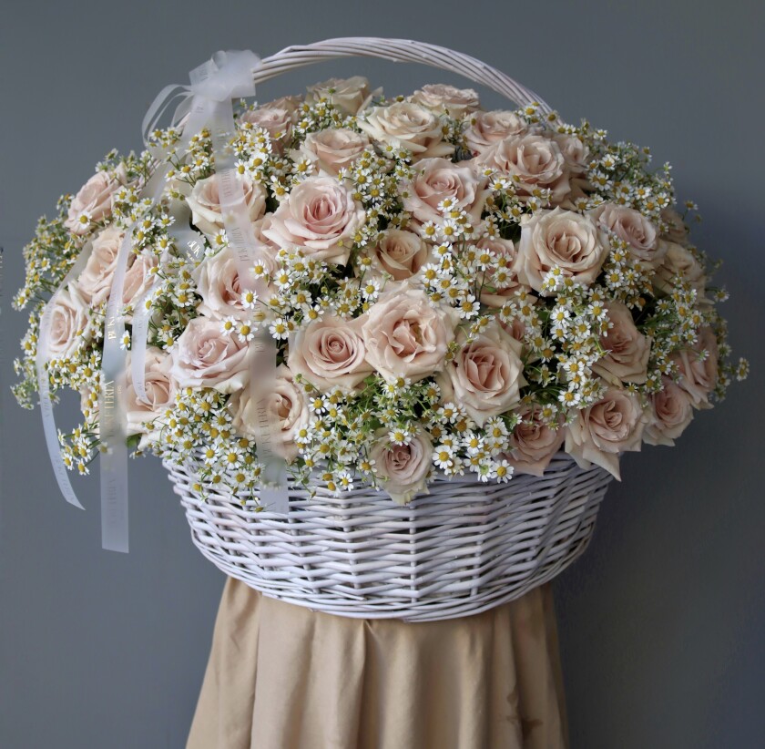 Blush garden roses in a rustic basket