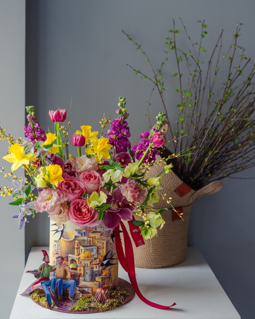 Decorative composition of red double tulips and peach garden roses