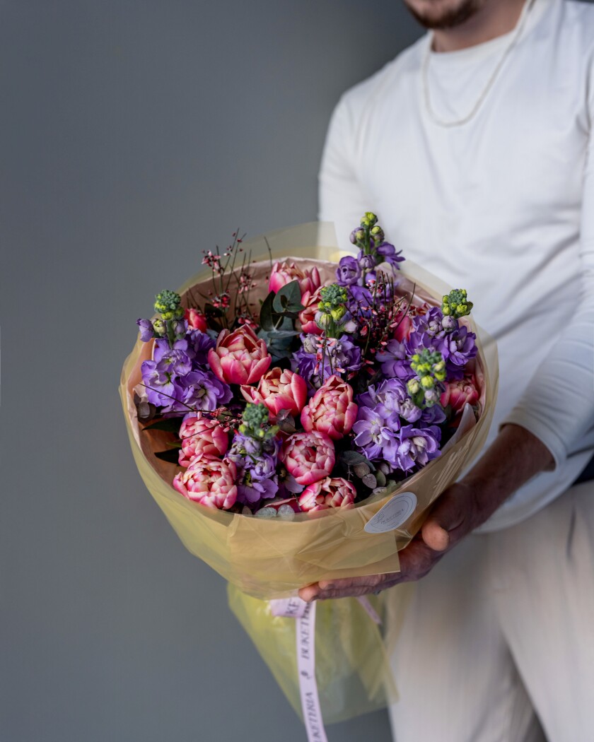Thirteen hot pink tulips with purple stock