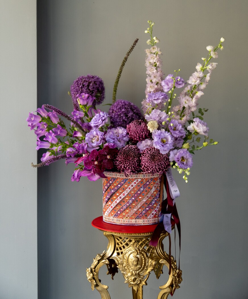 Decorative composition of purple vanda orchids and lavender delphiniums