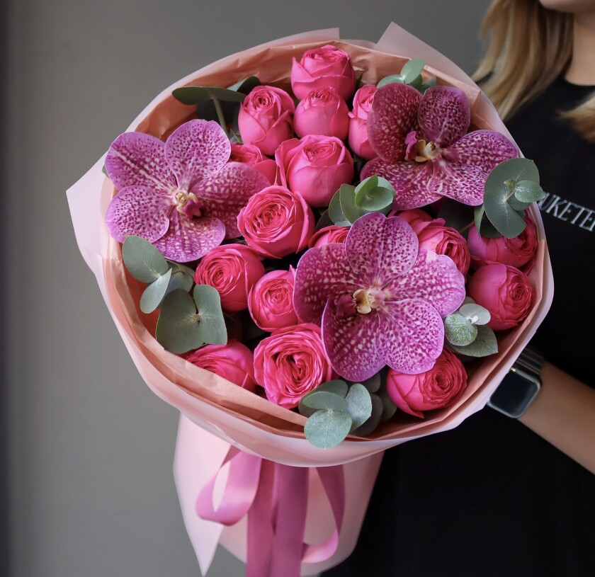 Four hot pink spray roses with three purple vanda orchids